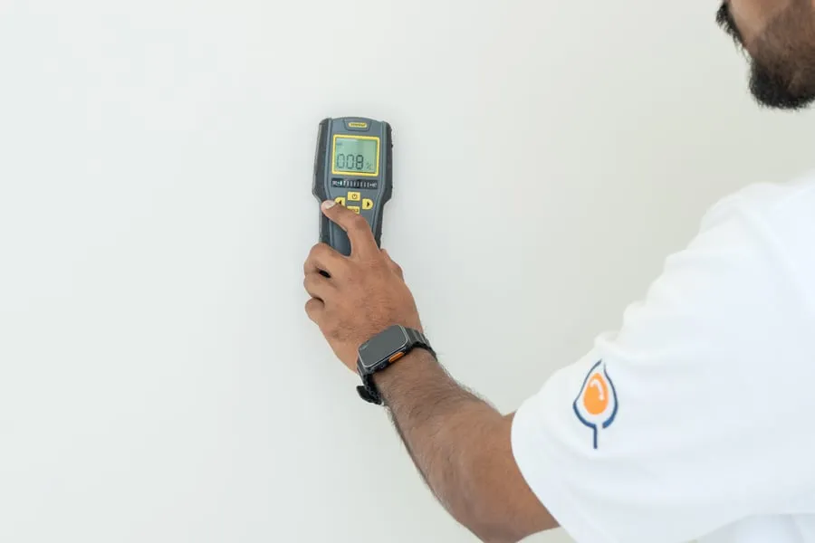 Moisture meter reading on a wall